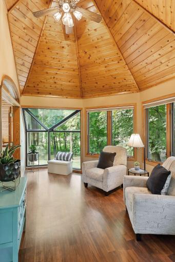 The octagon sunroom offers stunning nature views and dramatic vault ceiling.