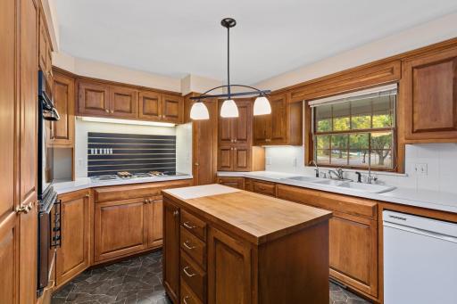 The birch cabinets are in excellent shape and surround this spacious kitchen with a separate island with butcher block top in the middle.