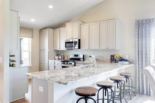 The popular Rushmore boasts a kitchen that is equal parts smart and useful - and comes loaded with a stainless steel appliance package. Photo of model home, finishes will vary.