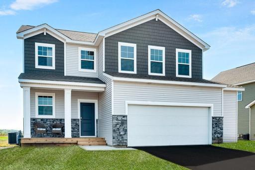 Welcome home to the NEW Sienna plan in Amberglen. Northern Craftsman exterior with stone, shakes and inviting front porch. Model photo - options and colors will vary.