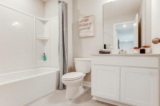 Additional upper-level full bath with quartz countertops. Model photos. Options and colors will vary.