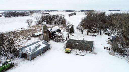 Various outbuildings including a small shed, chicken coop, pole barn, dairy and hog barns.