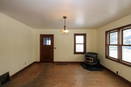 Dining room with hardwood floors and a corn stove (ignitor does not work).