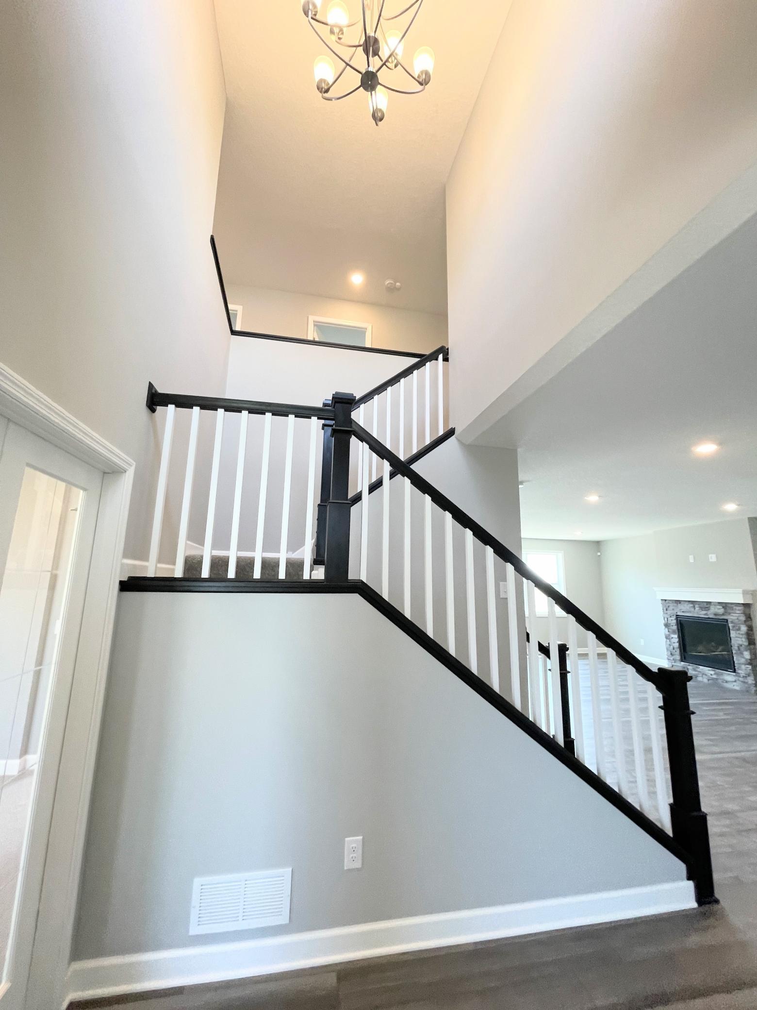 The 2-story foyer provides a light and airy space at your front entry. Photos are of the actual home.