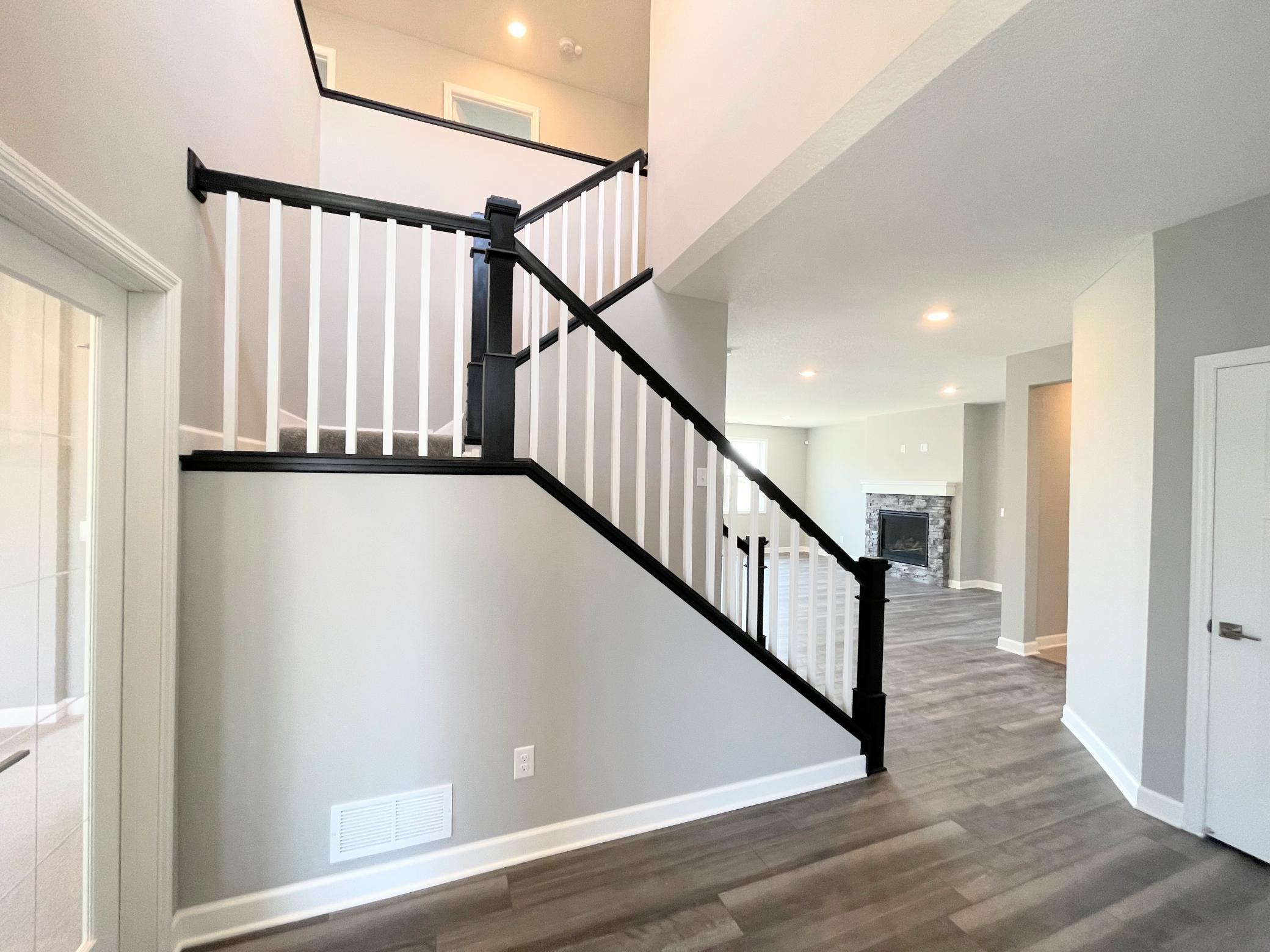 The elegant staircase makes an elegant statement at your front entry. Imagine the fun you can have with Photos are of the actual home.