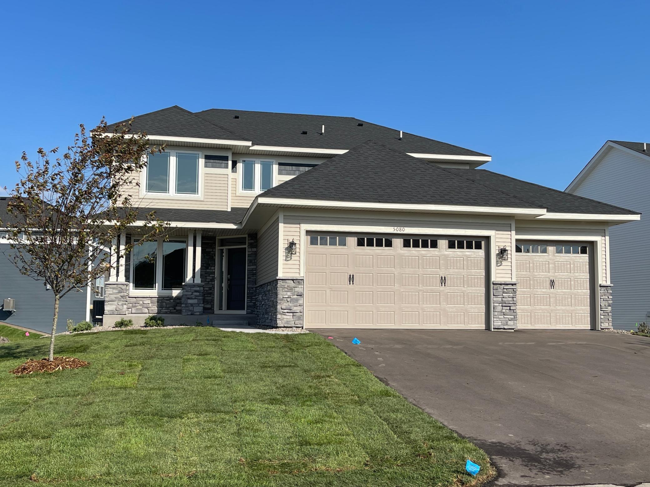 SOLD! Gorgeous Slate grey stone accents! Impressive 2-story foyer. Monterey Sand tan siding & Midnight Blue shakes. This is the popular Springfield 2-story floor plan. Irrigation, landscaping & sod included and installed!