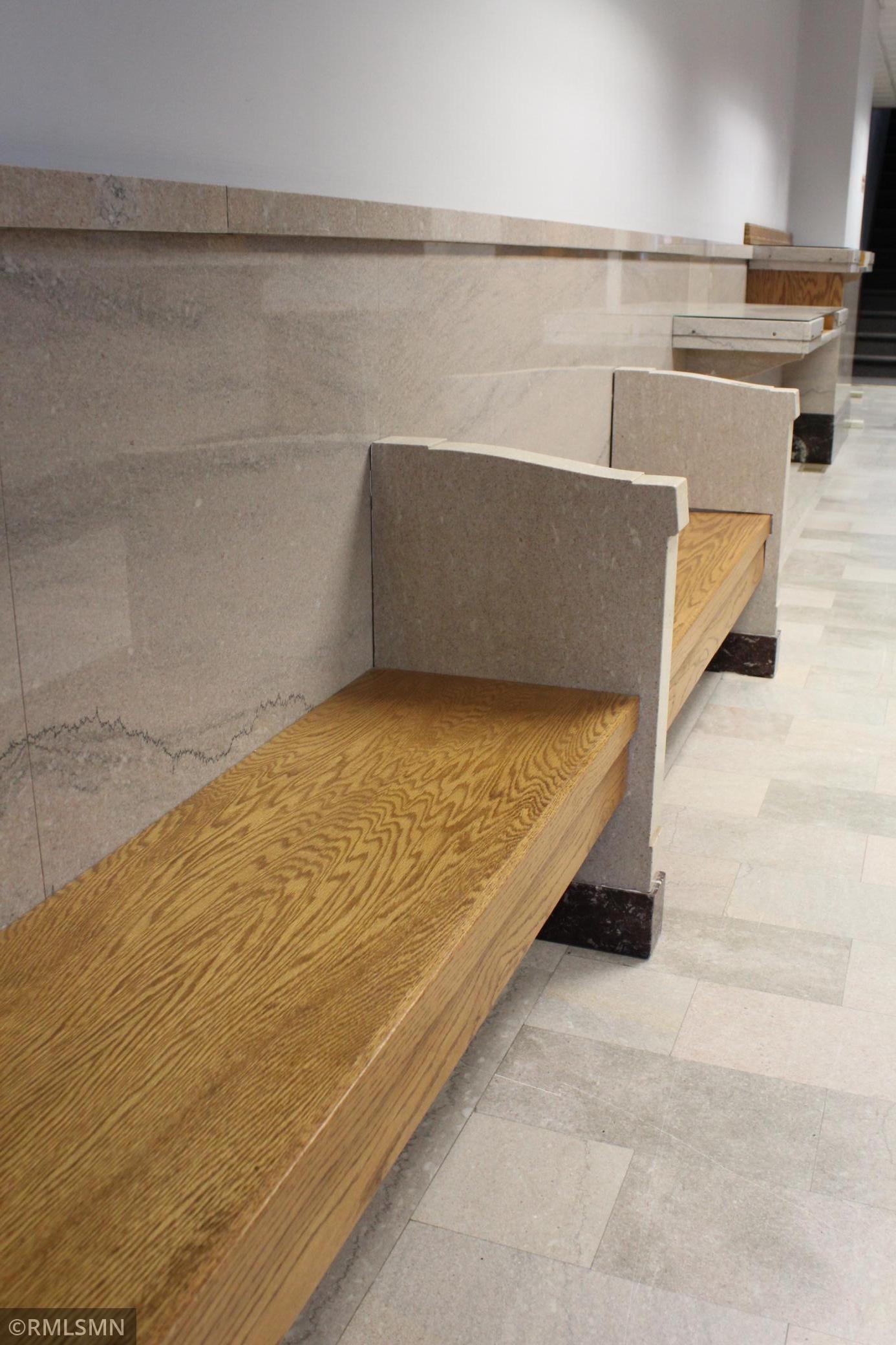 Built-in Benches with stone wall paneling and stone flooring