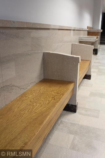 Built-in Benches with stone wall paneling and stone flooring