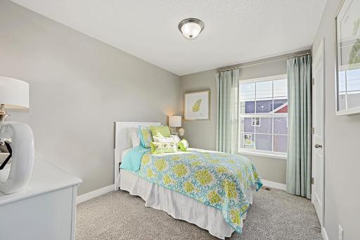 Another bedroom on the upper level. Photos from previous model home, finishes and options to vary.