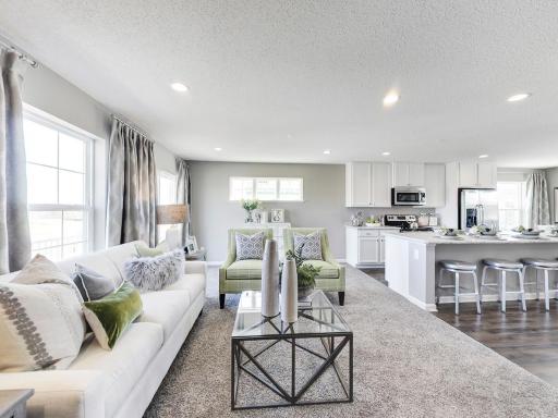 Gorgeous living space for family and friends to gather. Electric fireplace included! Photo of model home, finishes and options may vary.
