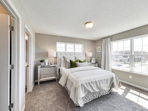 Primary suite includes walk in closet and private 3/4 bathroom. Photos from previous model home, finishes and options to vary.