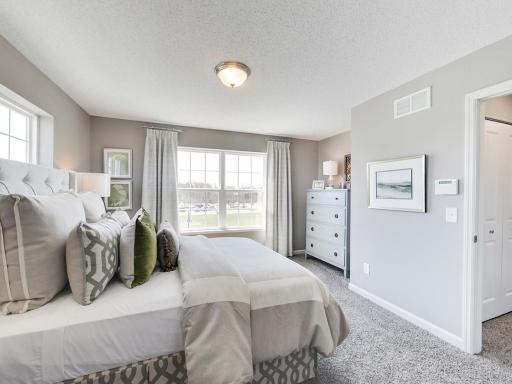 Primary suite is located away from the other two bedrooms to allow for privacy. Photos from previous model home, finishes and options to vary.