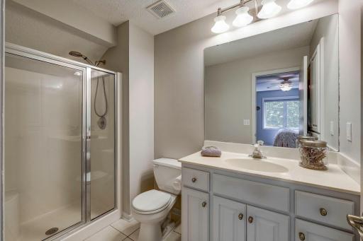 Master bath with walk-in shower and tile floors.