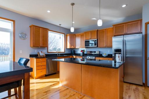 Gleeming kitchen with granite counters, SS appliances and gas stove.jpg