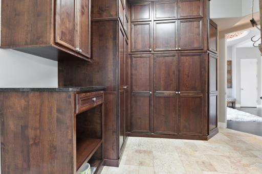 The mud room was refreshed with extensive cabinetry that houses a stacking washer and dryer along with ample storage space.