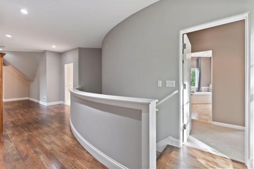 The upper level enjoys hardwood floors that flow through the hallway.