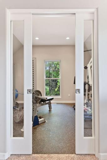 Photo for 1450 W Farm Road, Chaska, MN 55318 - Listing #6113107 Sliding glass pocket doors open into the exercise room.