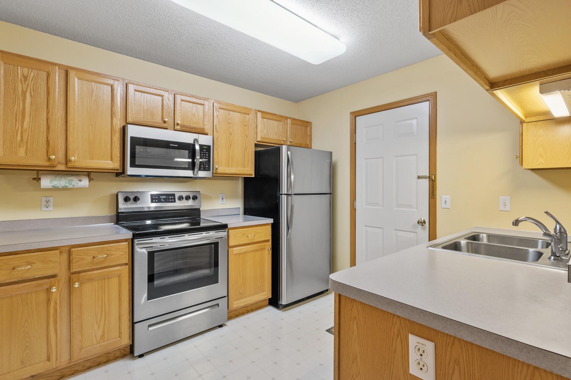 Stainless steel appliances and half bath right off the kitchen