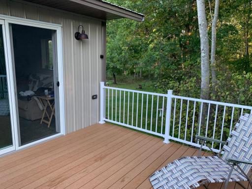 New Deck has composite deck flooring, out through sliding doors of the large primary bedroom.