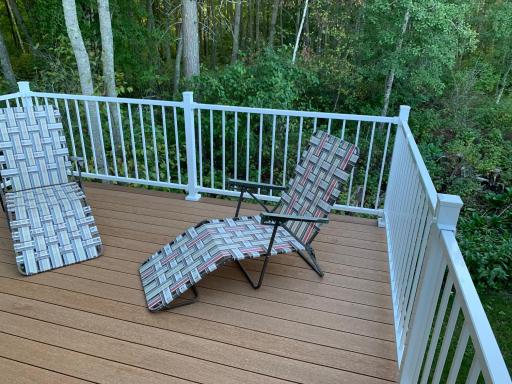 Deck with wooded surroundings, great outdoor setting.
