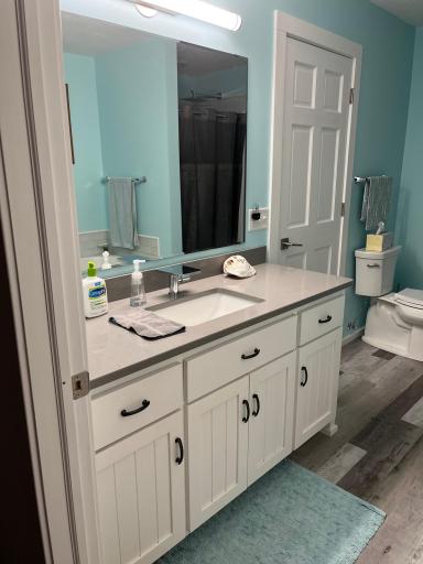 UL bathroom has quartz countertop vanity. Door at the left enters the primary bedroom.