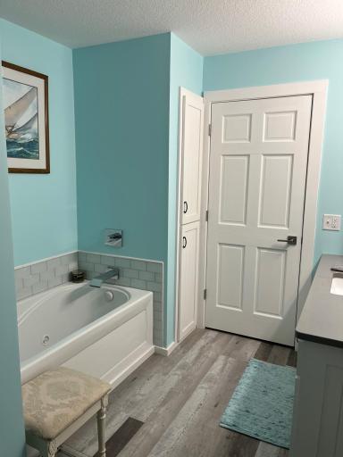 UL bath has a whirlpool tub and add'l linen/towel closet. The door straight ahead enters to hallway.