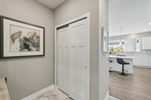 This spectacular owner's entry provides enough space for benches, lockers and cubbies. Plus, enjoy the spacious entry closet and quick access to the kitchen. (Photo of decorated model, actual home's finishes may vary slightly)