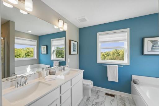 The owner's bathroom features a soaking tub, a separate shower and double-vanity. (Photo of decorated model, actual home's finishes may vary slightly)