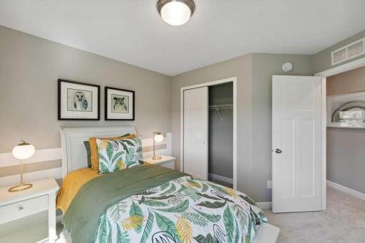 The third generously sized secondary bedroom with a spacious closet. (Photo of decorated model, actual home's finishes may vary slightly)