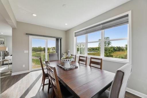 This lovely morning room enjoys three sides of windows and is a great space to have a large dining room table! (Photo of decorated model, actual home's finishes may vary slightly)