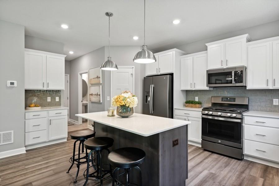 Kitchen offers elegant coffee bistro, shown on the left, a gas range and walk-in pantry.
