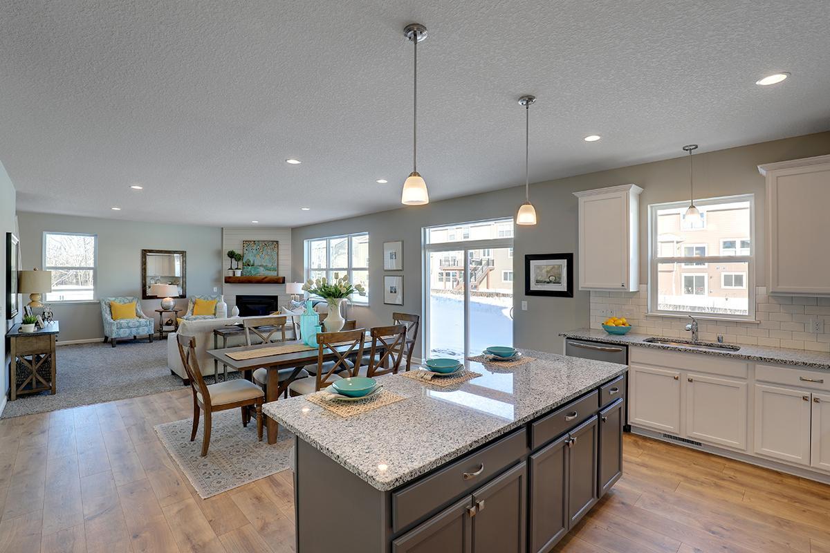 The open-concept floor plan epitomizes itself in a plan that flows seamlessly from kitchen to dining to the family room! Photos of model, colors and options will vary.