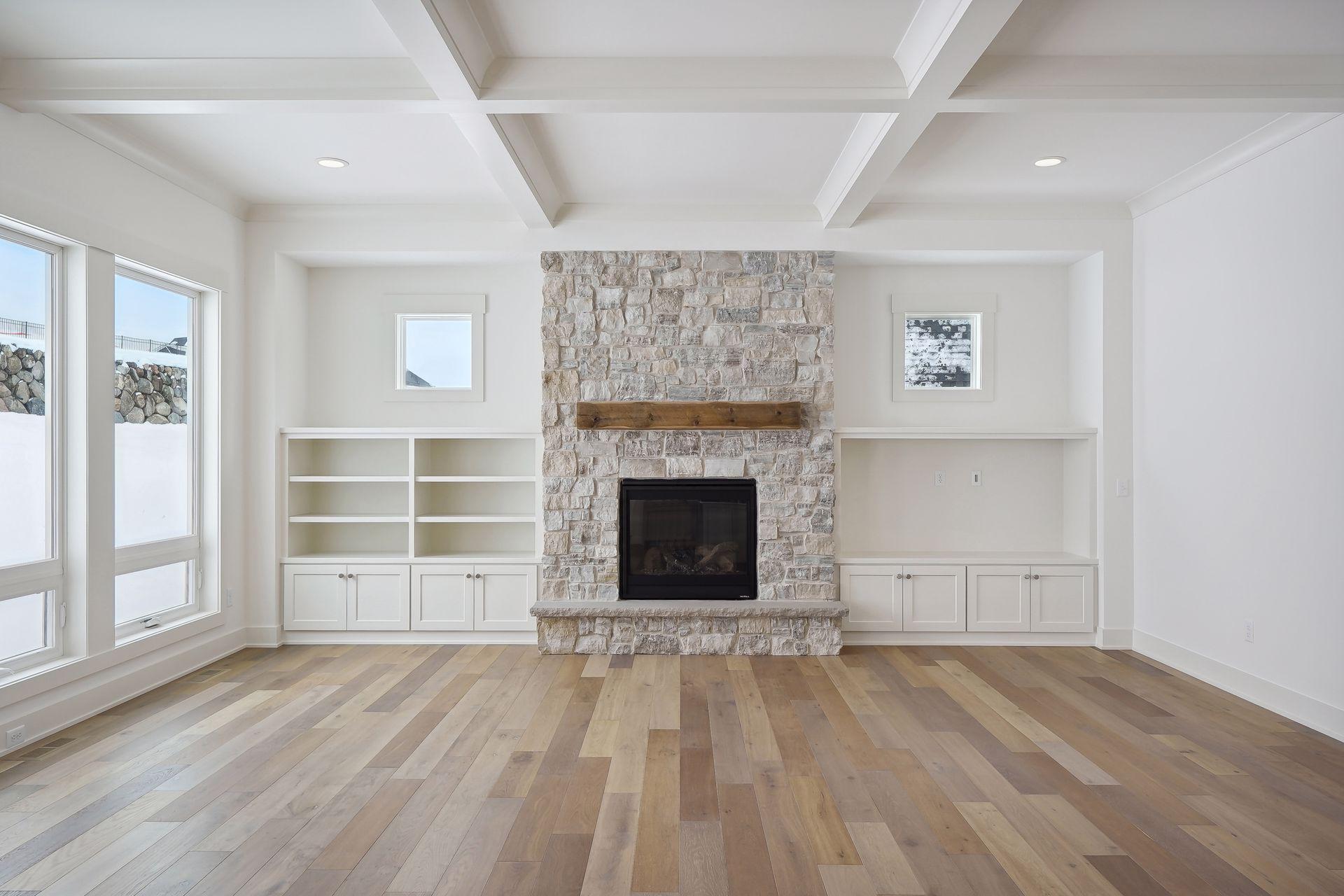 Main floor fireplace with stacked stone to ceiling, built-ins