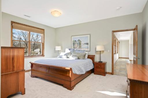 The lower level bedroom suite offers views to the private backyard and a full bath.
