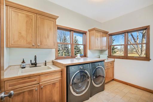 The large laundry room boasts ample storage as well as a convenient folding area.
