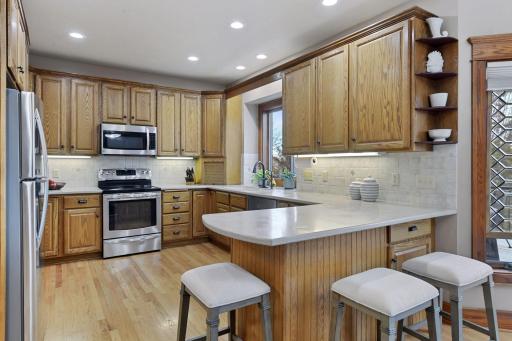 Kitchen has stainless steel appliances, tile back splash, Corian counter tops and solid custom cabinetry.