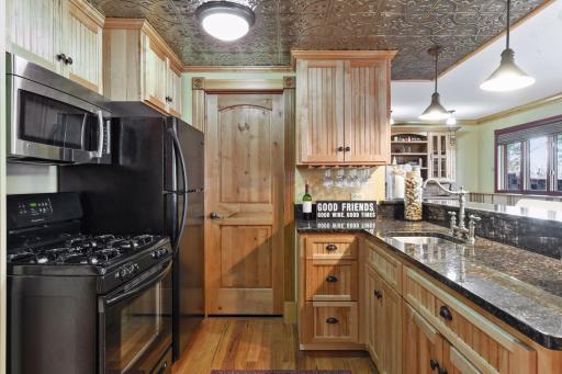 Copper ceiling, bead board solid cabinets, ample storage and large refrigerator for beverages needed when entertaining in a lake home.