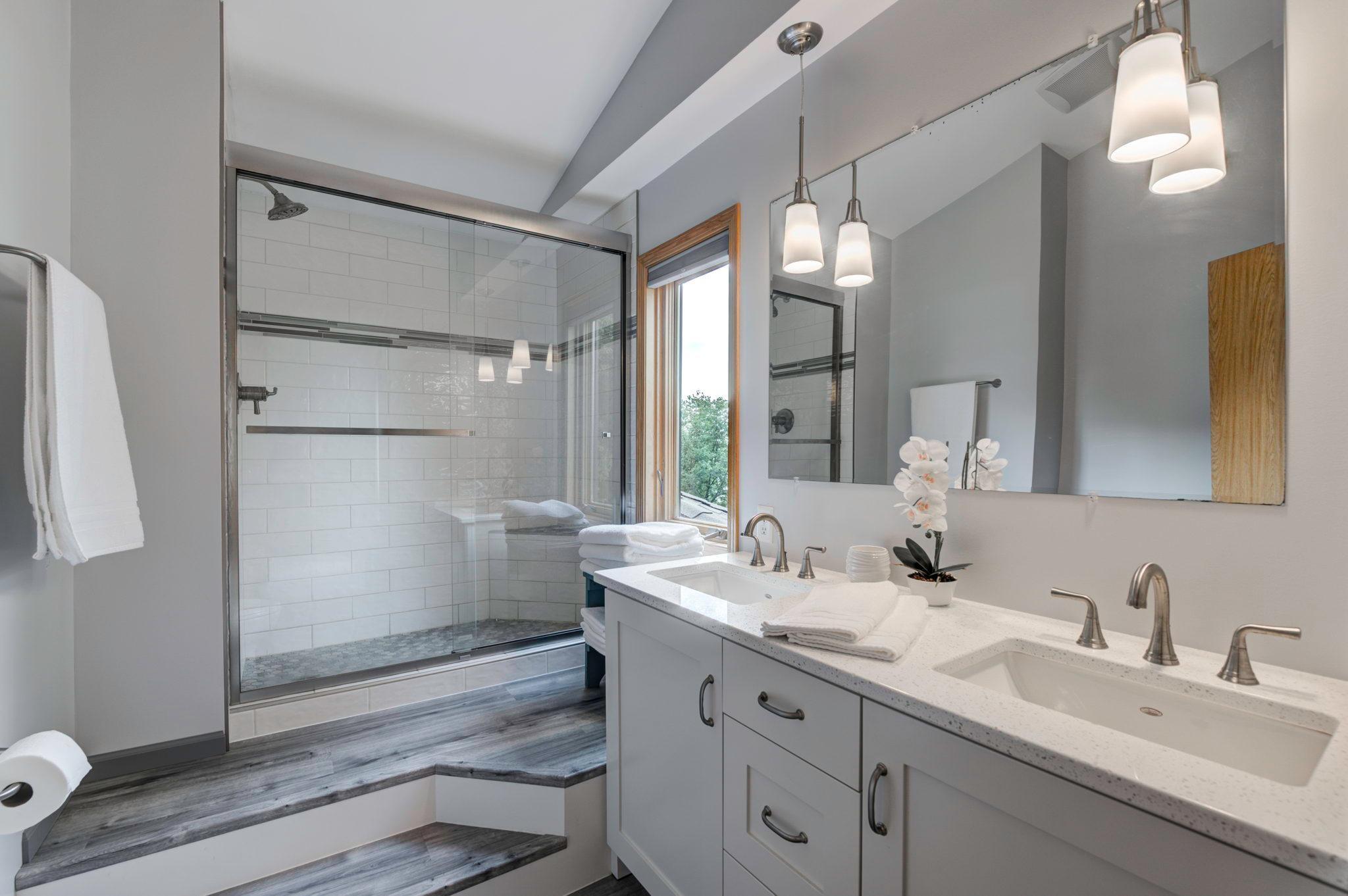 The private master bath was updated in 2022 and features a dual sink vanity with plenty of storage and a walk-in tile shower