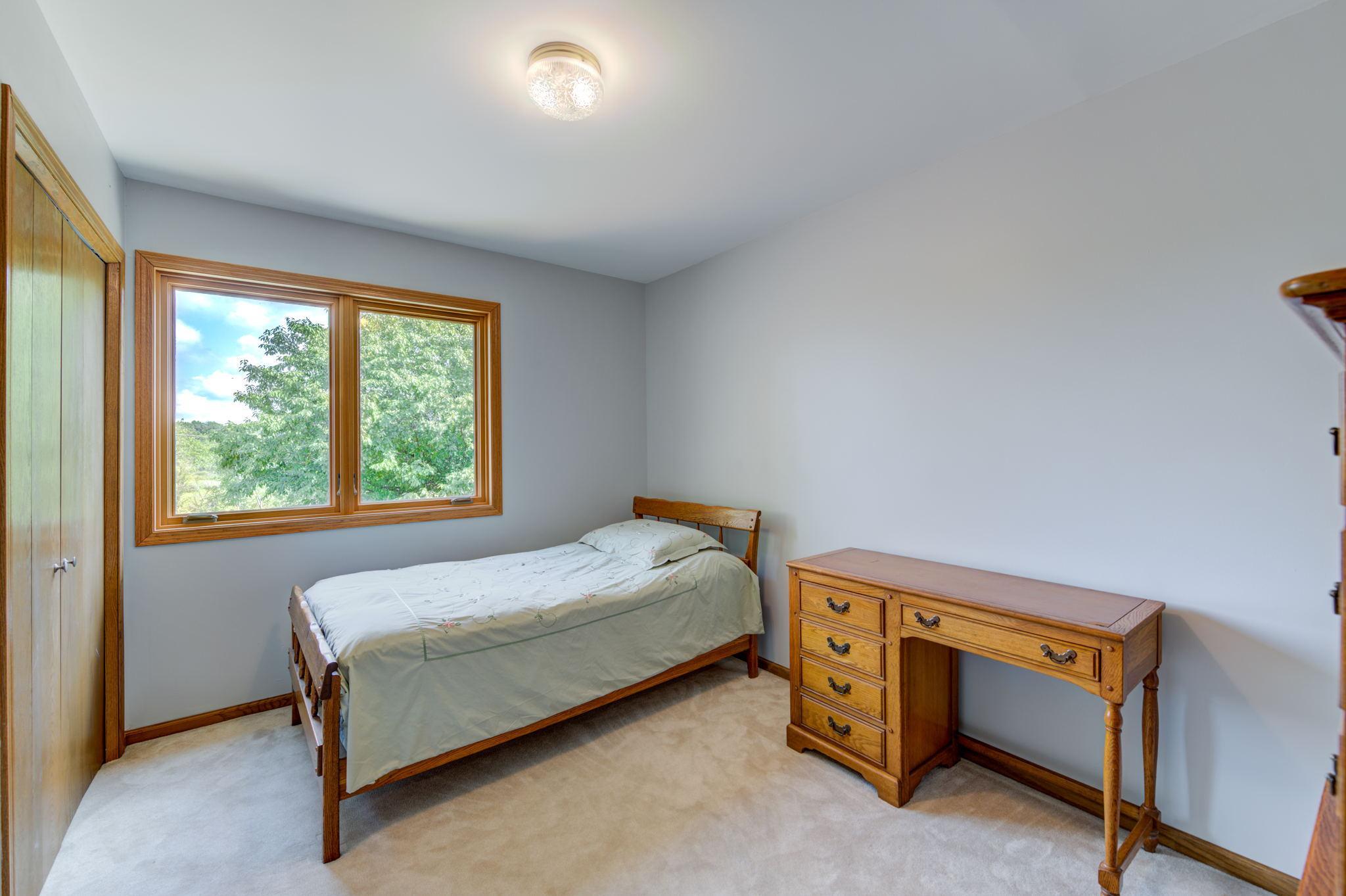 View of the third bedroom on the upper level. You will appreciate all this property has to offer from the mature trees to the privacy and all the wildlife that surrounds this home!