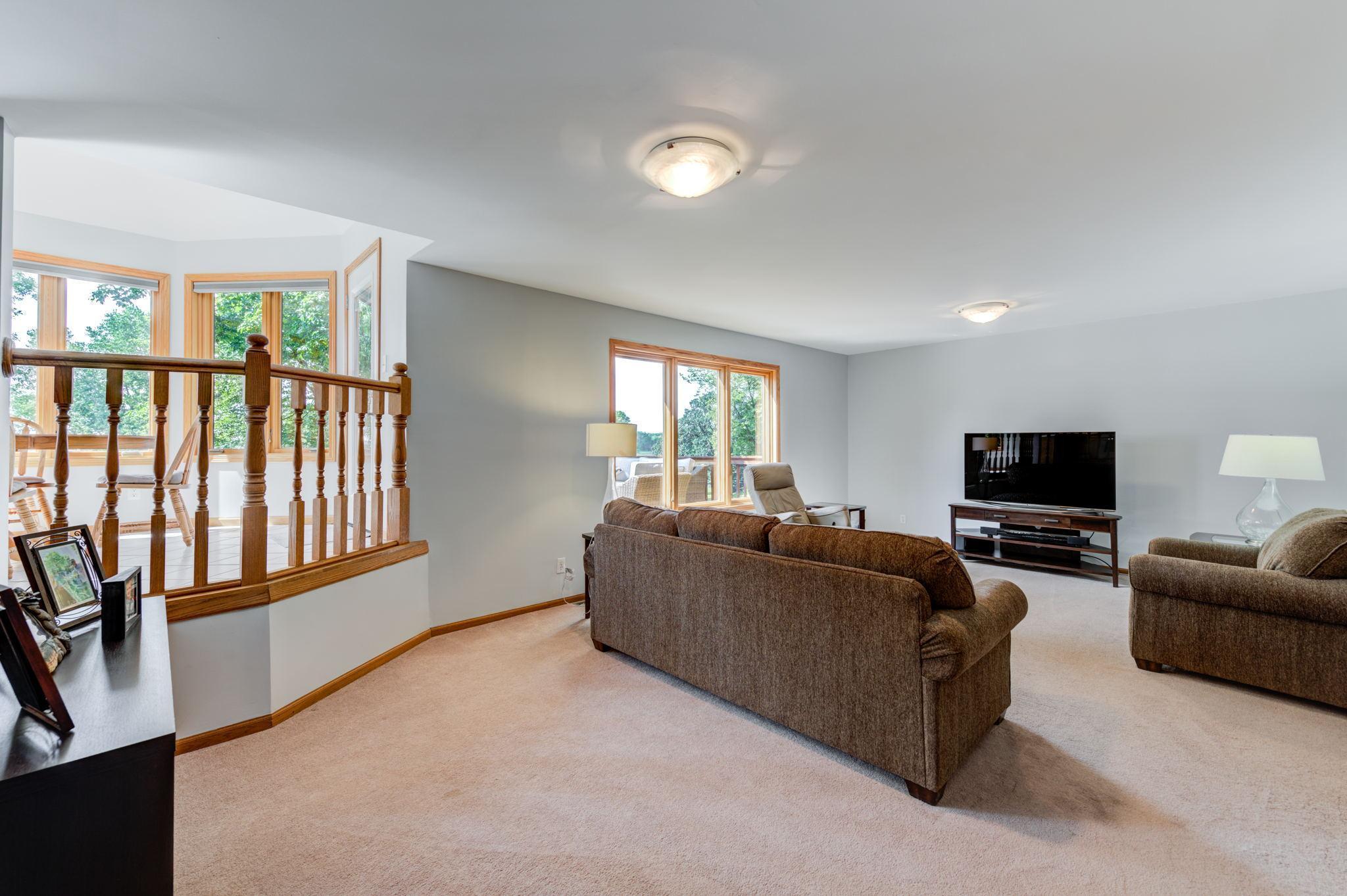 The main floor living room is open to the kitchen and features a large picture window looking out to the lake!