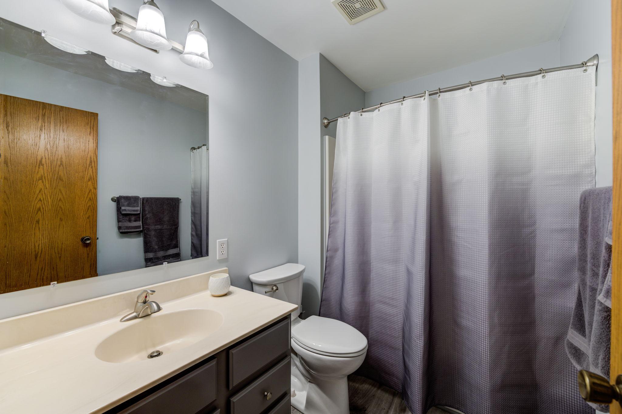Across from the upper-level bedrooms is a full bath that has been updated with vinyl plank flooring.