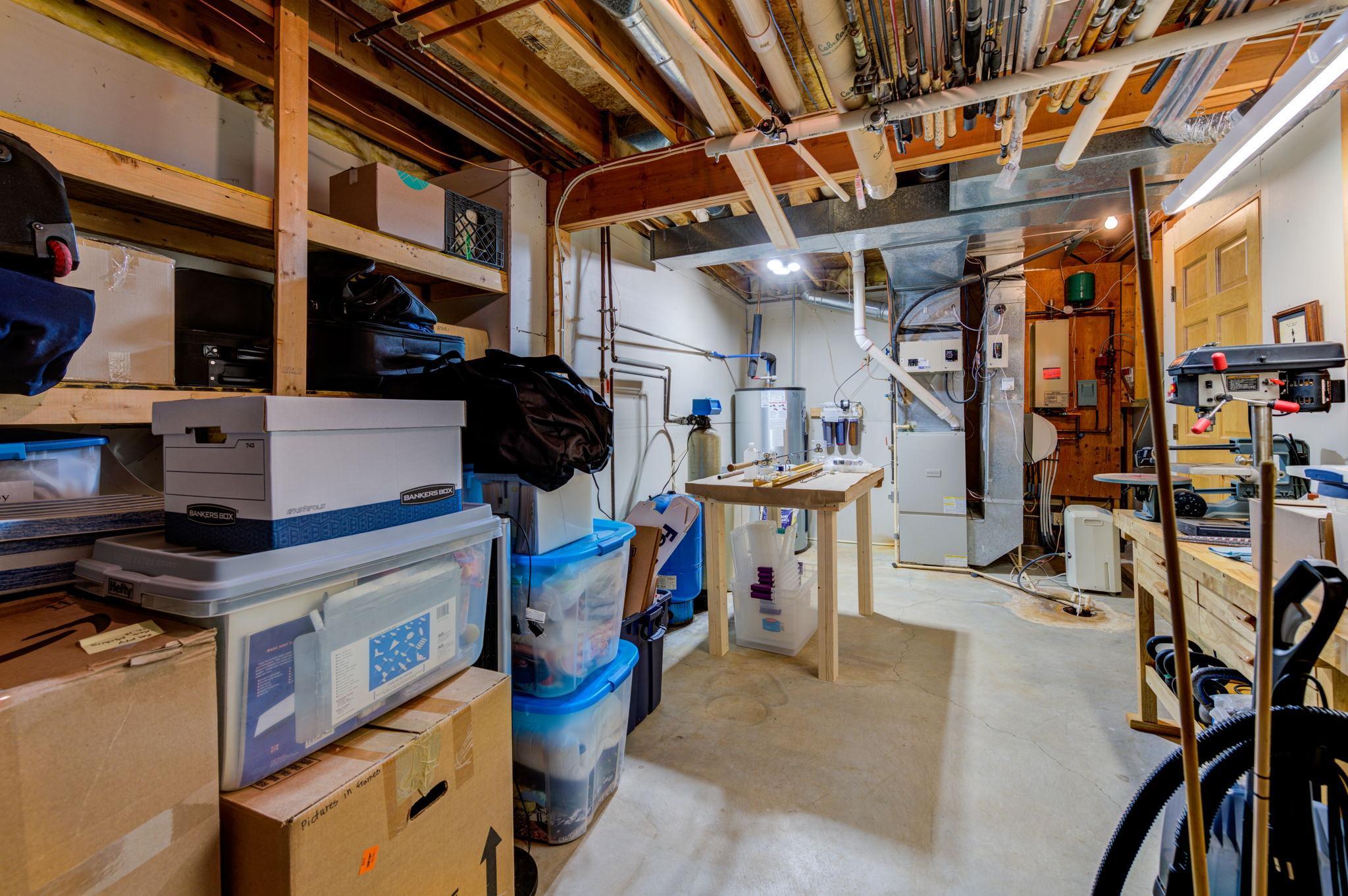 Lower-level utility room offers even more storage in this home. With an updated water heater, dual fuel furnace as well as in-floor heat throughout the basement this home is ready to go!
