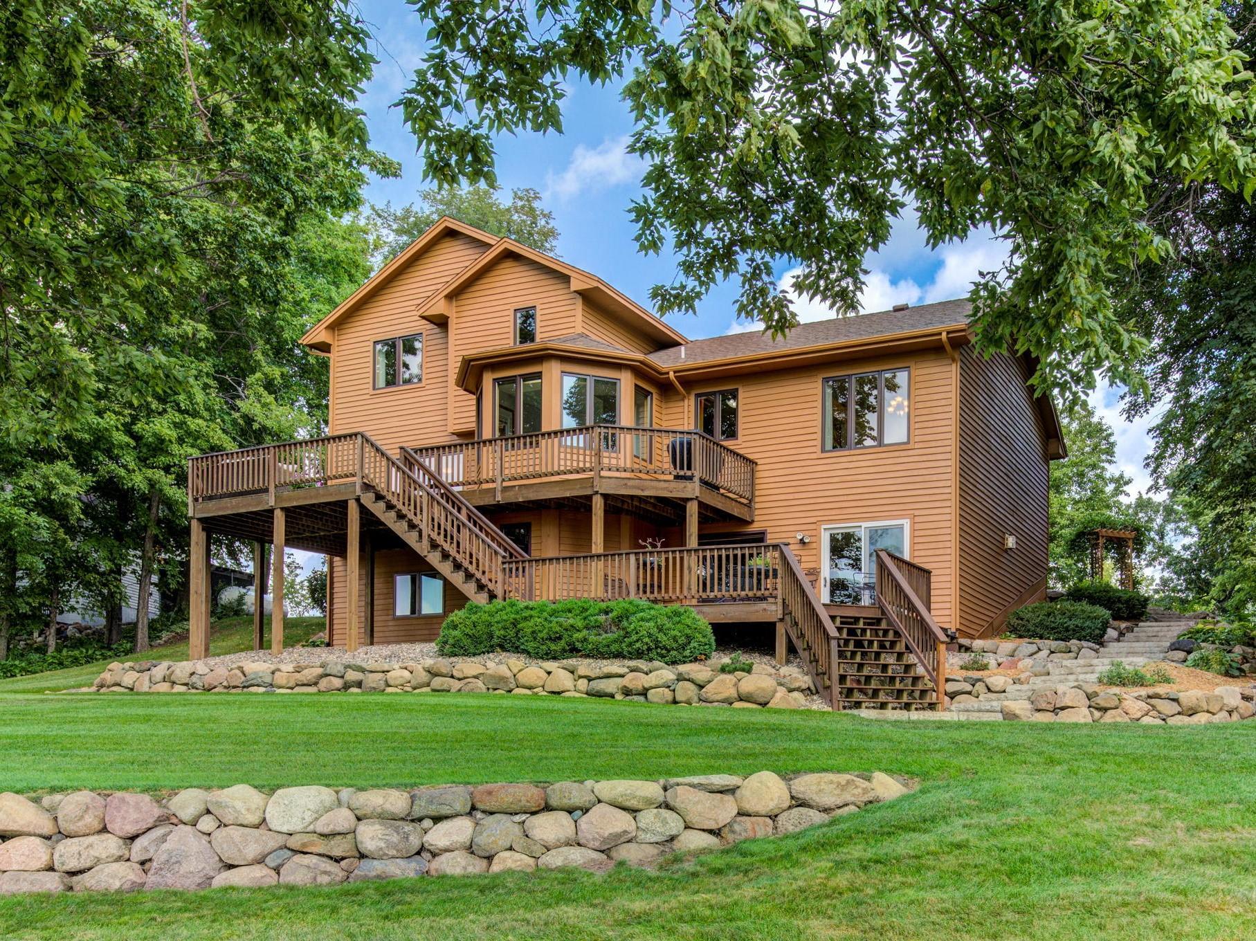 This home offers many great entertaining areas from the multi-level deck to the large, usable, slow sloping lot down to the lake.