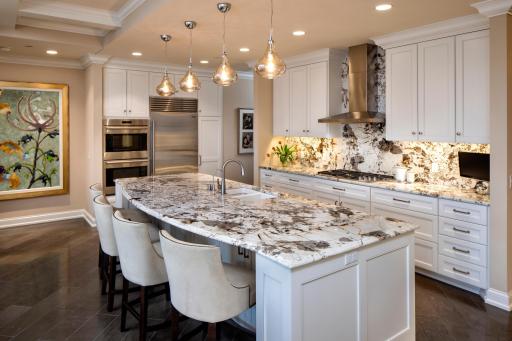 High-end appliances, gas cooktop, double ovens, and a large center island make this a cook's dream kitchen