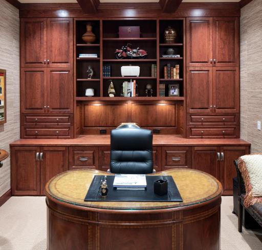 Stately built-in cabinets and box beam ceiling detail in the designated home office space