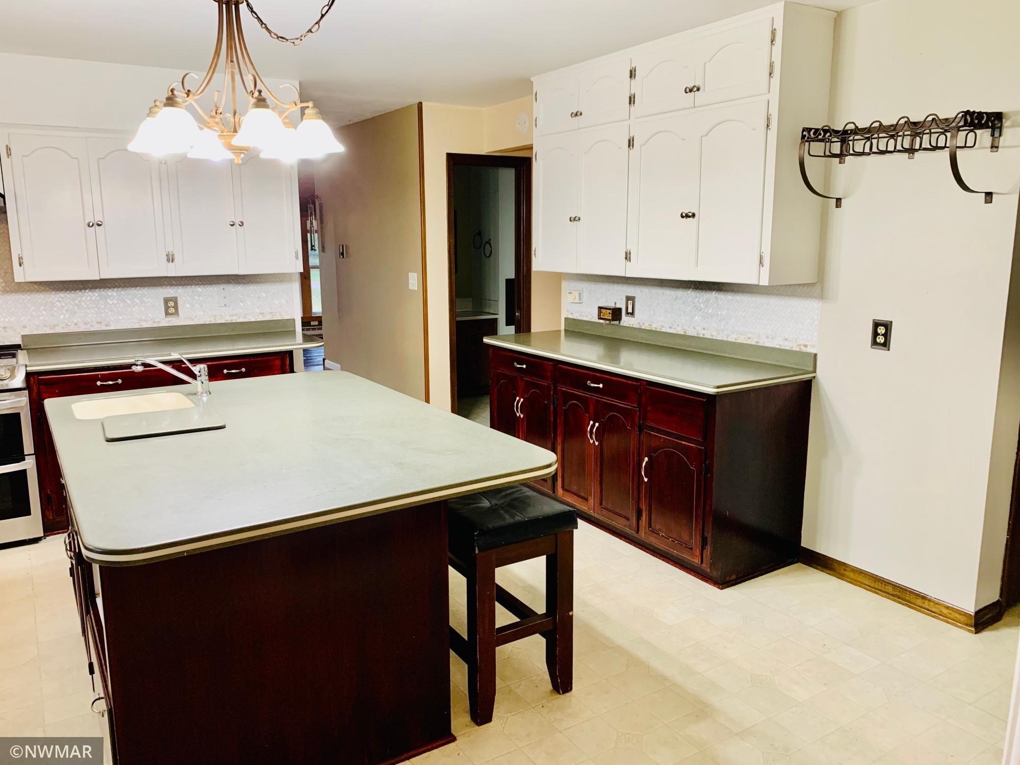 Large updated kitchen with mother of pearl tiled backsplash