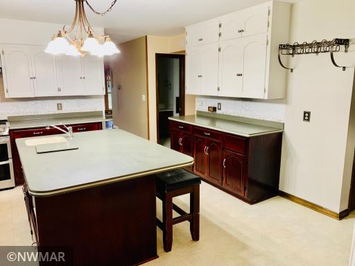 Large updated kitchen with mother of pearl tiled backsplash