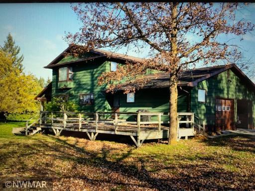 Large Oak trees shade the back deck