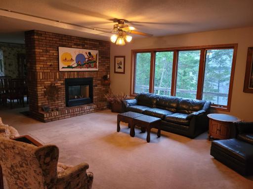 Large windows and fireplace make this living room a great gathering spot