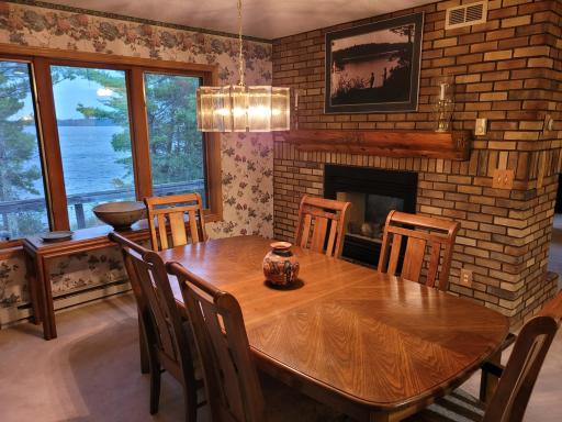 Dining Room with views to the lake with the cozy of fireplace
